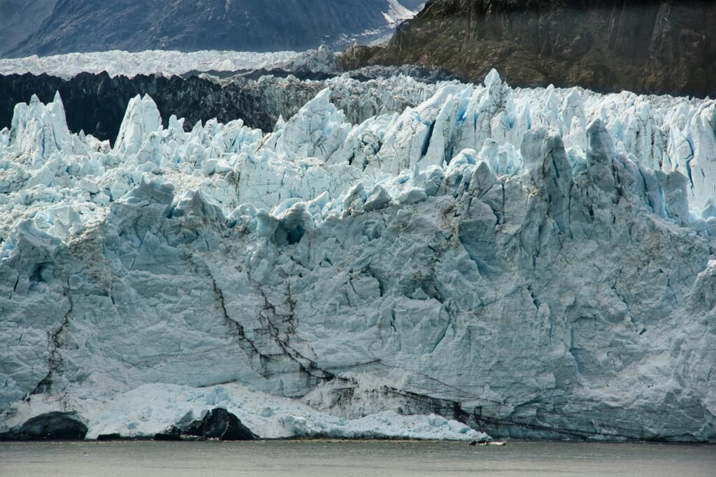 pexels-photo-3675499-3675499 A breathtaking view of a massive glacier in Alaska, showcasing its icy formations and rugged beauty.